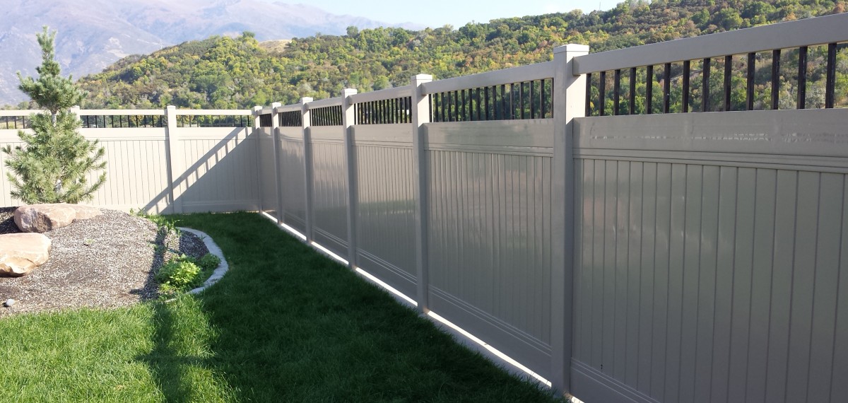 Homeland privacy vinyl fence installed along a residential property line