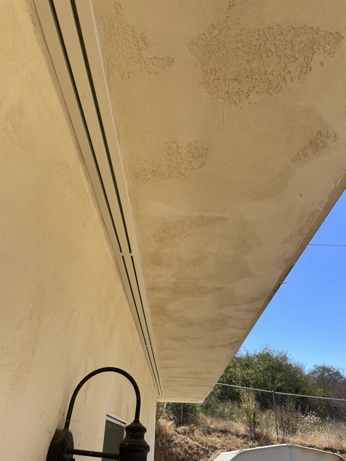 Ember-resistant continuous soffit vent running along a home's eave