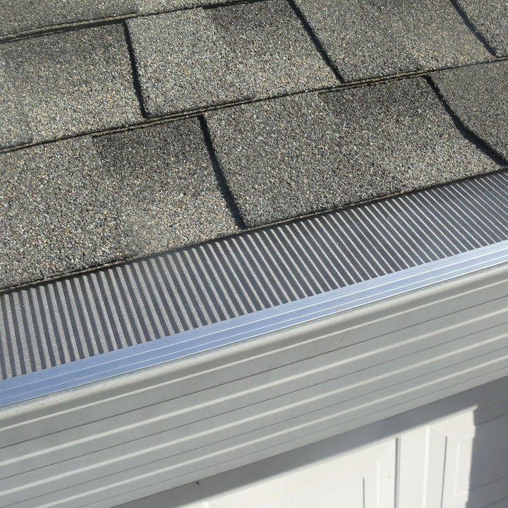 Installed micro-mesh gutter guard on an asphalt shingle roof